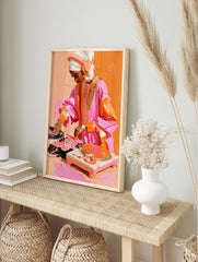 Modern illustration of a DJ with a headscarf mixing music on a turntable in vibrant orange, in an alternate framed mockup