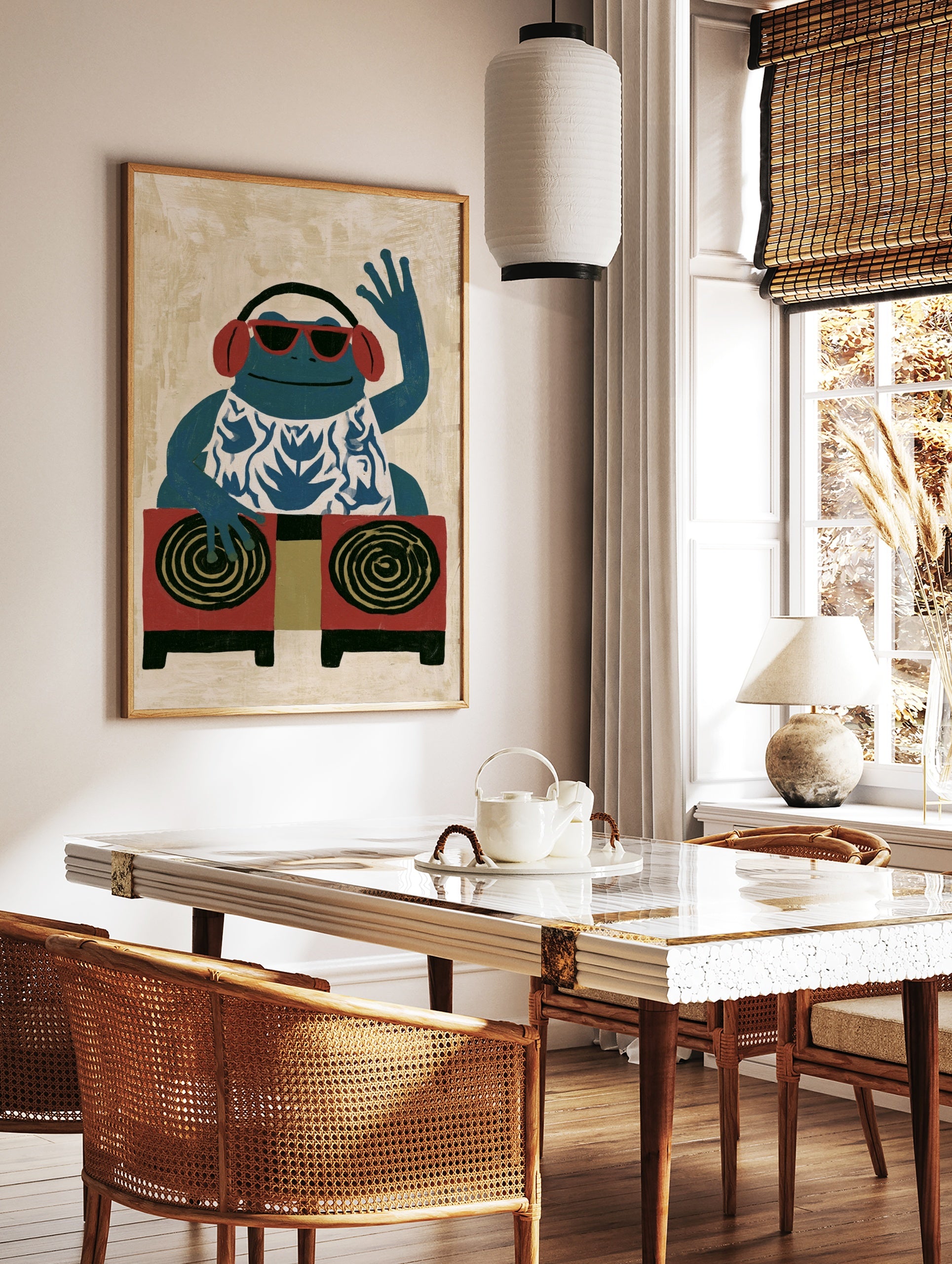 Illustrative blue frog DJ art print wearing red sunglasses and headphones, in a styled room mockup