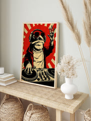 DJ frog wall art print featuring a toad with sunglasses and headphones at a mixing deck on a, in an alternate framed mockup