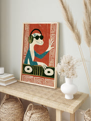 DJ lizard wearing headphones and sunglasses, playing a turntable, illustrative art print on a, in an alternate framed mockup