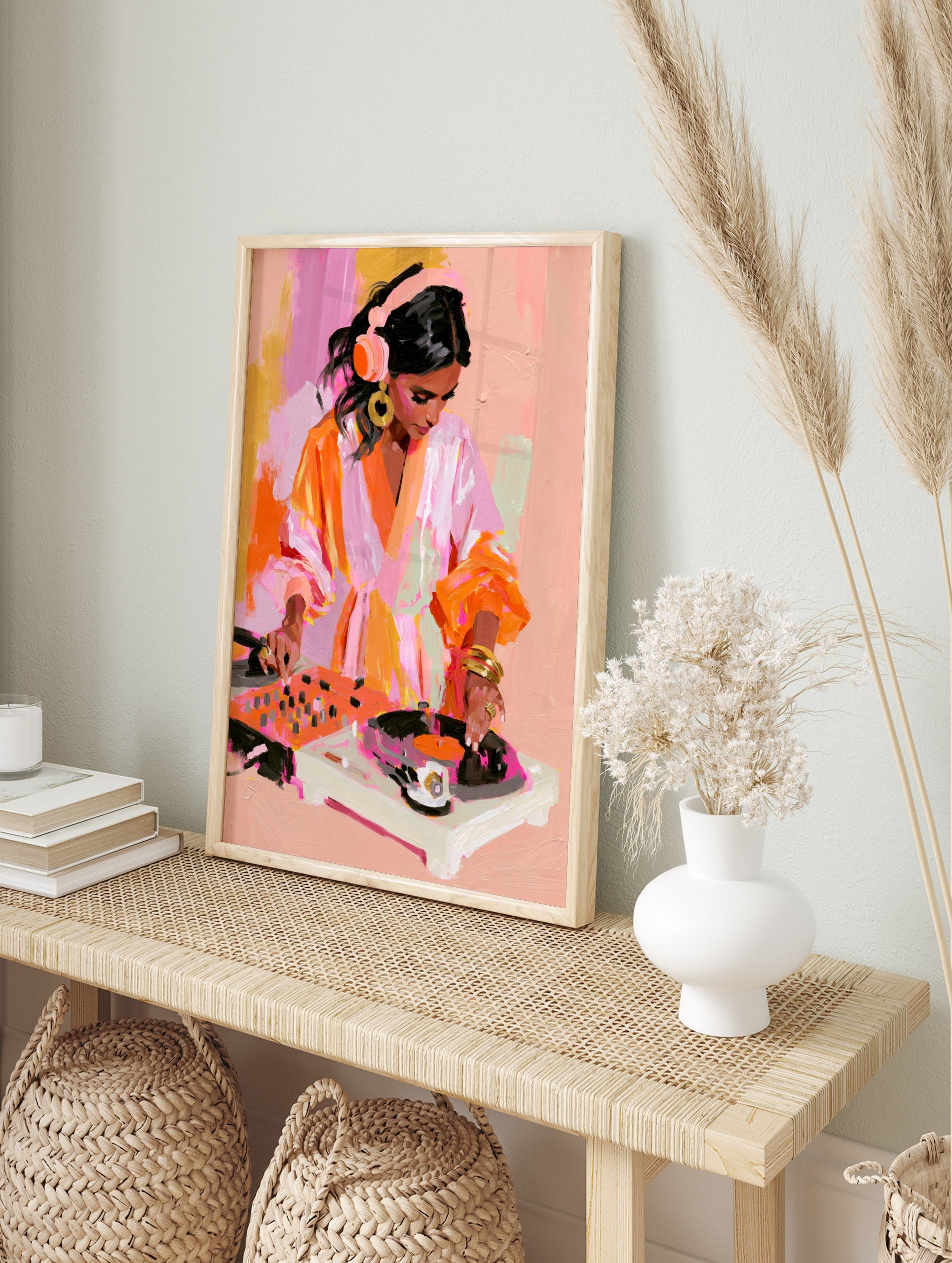Painterly illustration of a female DJ wearing headphones mixing on turntables in vibrant pink, in an alternate framed mockup