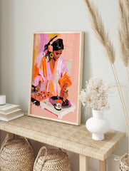 Painterly illustration of a female DJ wearing headphones mixing on turntables in vibrant pink, in an alternate framed mockup