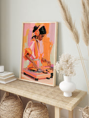 Painterly illustration of a female DJ with headphones mixing music, in vibrant shades of, in an alternate framed mockup