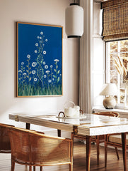 Illustrative DNA helix intertwined with white flowers, green leaves, and grass on a deep blue, in a styled room mockup