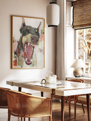 Abstract painting of a Doberman dog with wide open mouth and bared teeth in dark grey, pink, and, in a styled room mockup