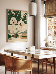 Illustrated wall art of a poodle and golden retriever on a picnic blanket with strawberries, a hat, in a styled room mockup