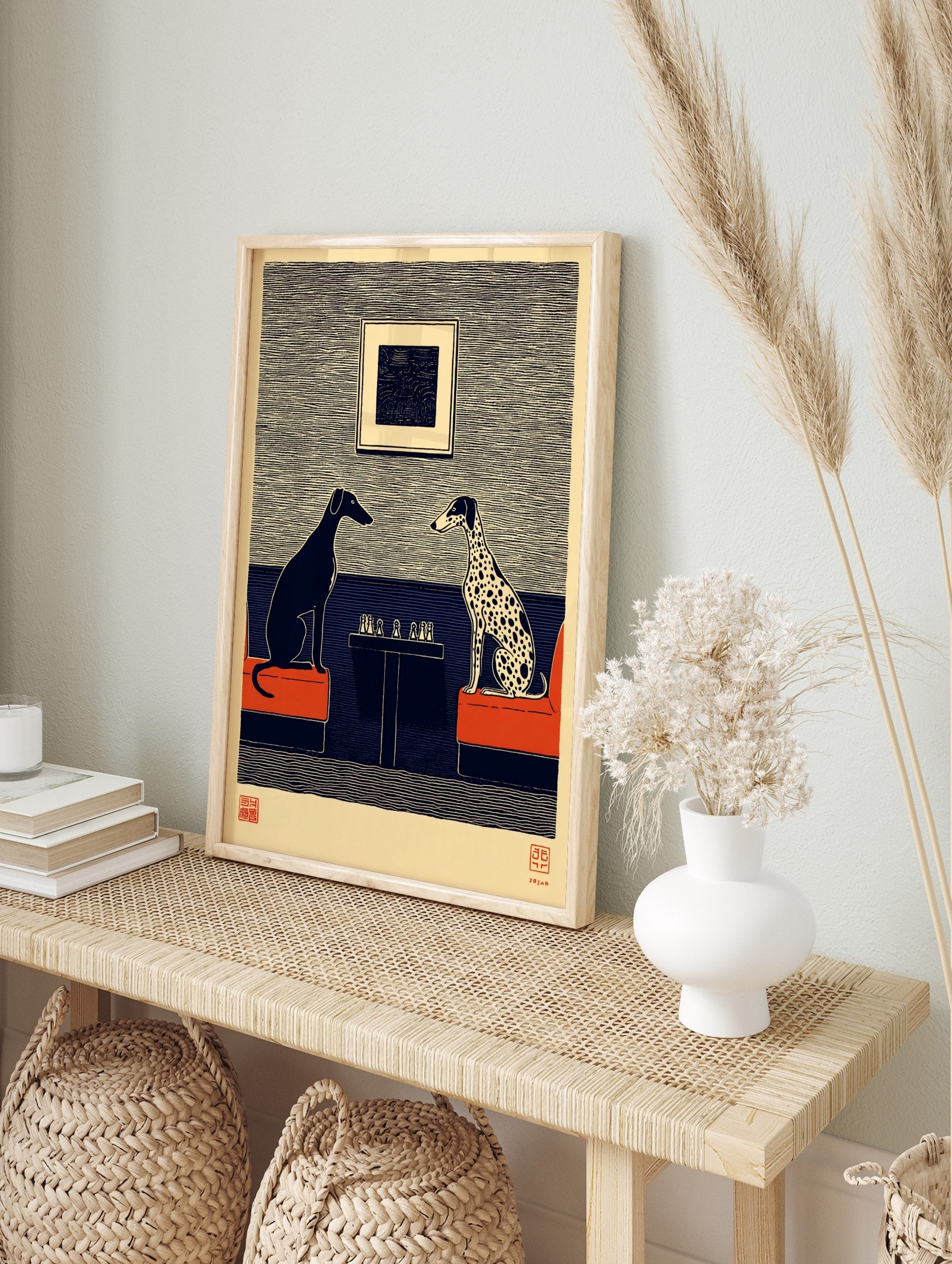 Illustrative print of black greyhound and spotted dalmatian playing chess on red sofas, blue, in an alternate framed mockup