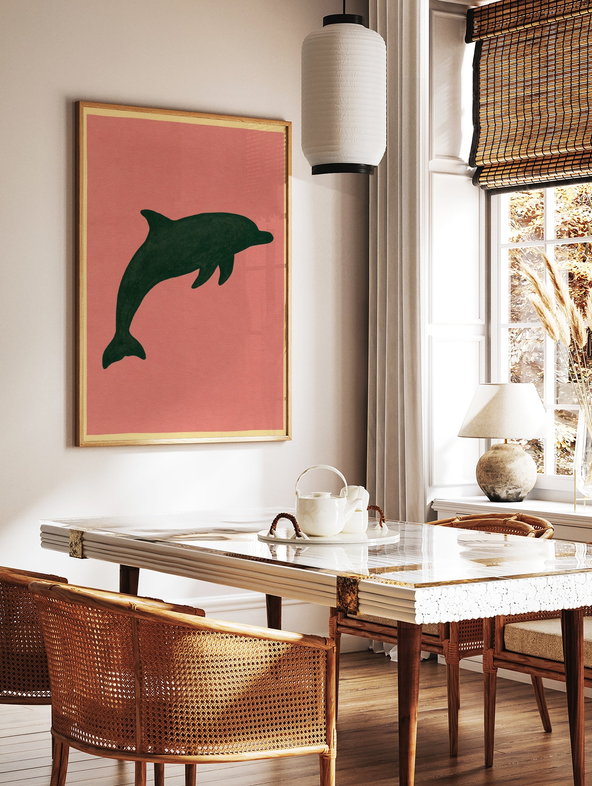 Minimalist dark green dolphin silhouette illustration on a muted pink background, unframed paper, in a styled room mockup