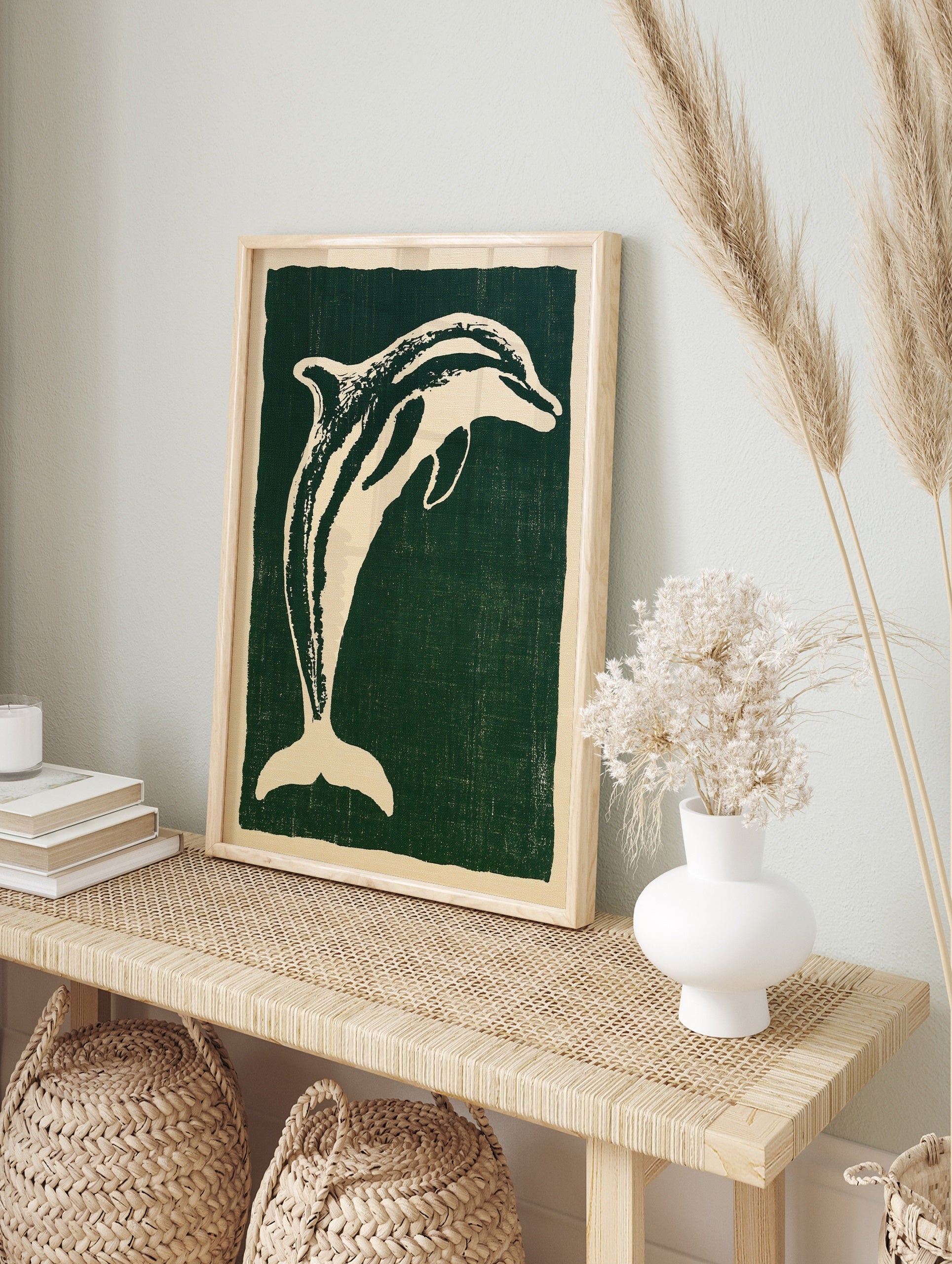 Stylised cream dolphin illustration on a deep green background, illustrative animal wall art, in an alternate framed mockup