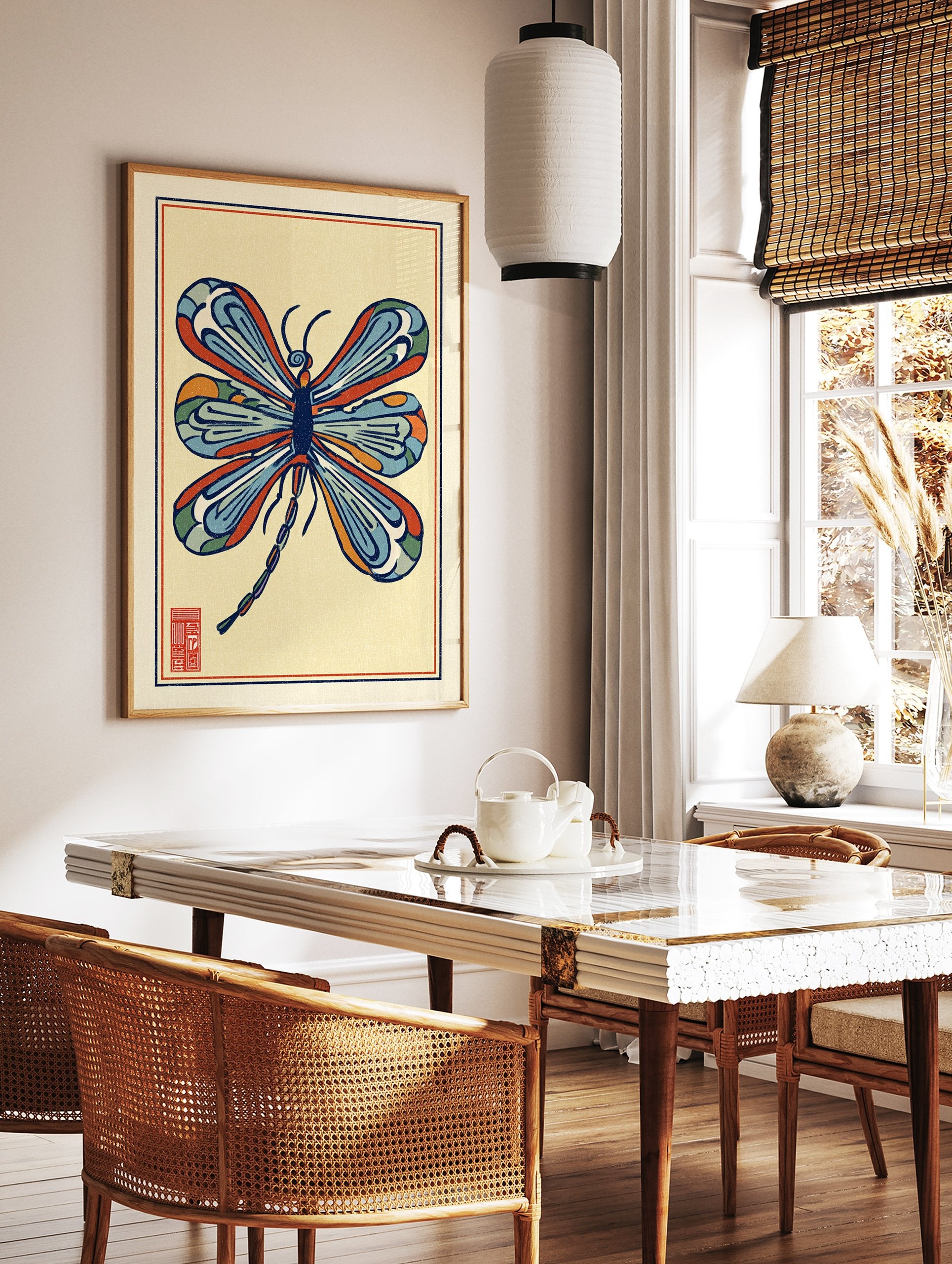 Stylized multi-color dragonfly illustration art print with blue, orange, and red wings on a light yellow background and a red seal. - Image 2