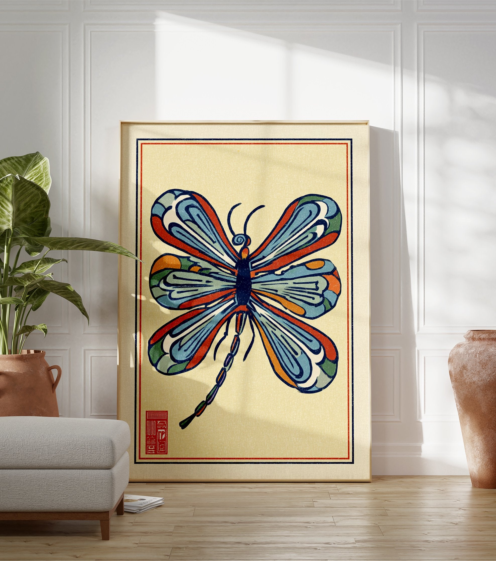 Stylized multi-color dragonfly illustration art print with blue, orange, and red wings on a light yellow background and a red seal. - Image 3