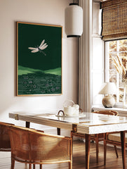White dragonfly illustration flying over green hills and a circuit board pattern in dark green water, in a styled room mockup