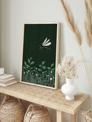 Illustrative dragonfly flying above green leaves growing from white circuit board patterns on, in an alternate framed mockup