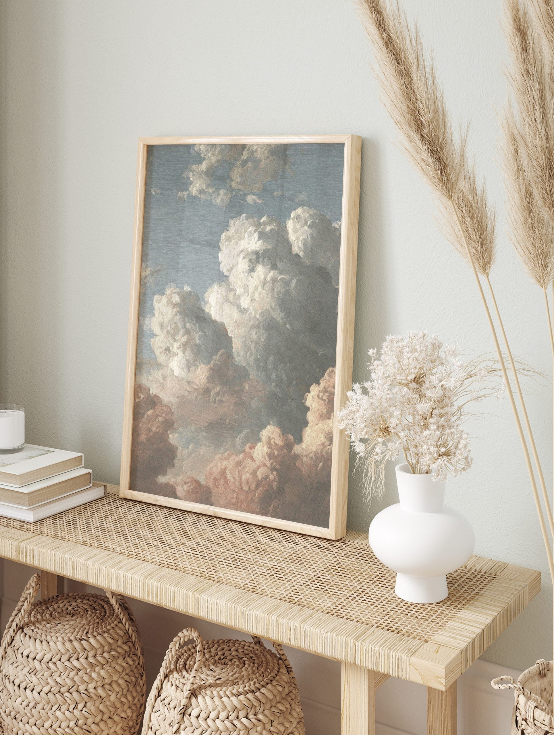 Painterly cloud study art print with white, grey, and pink clouds against a blue sky, in an alternate framed mockup
