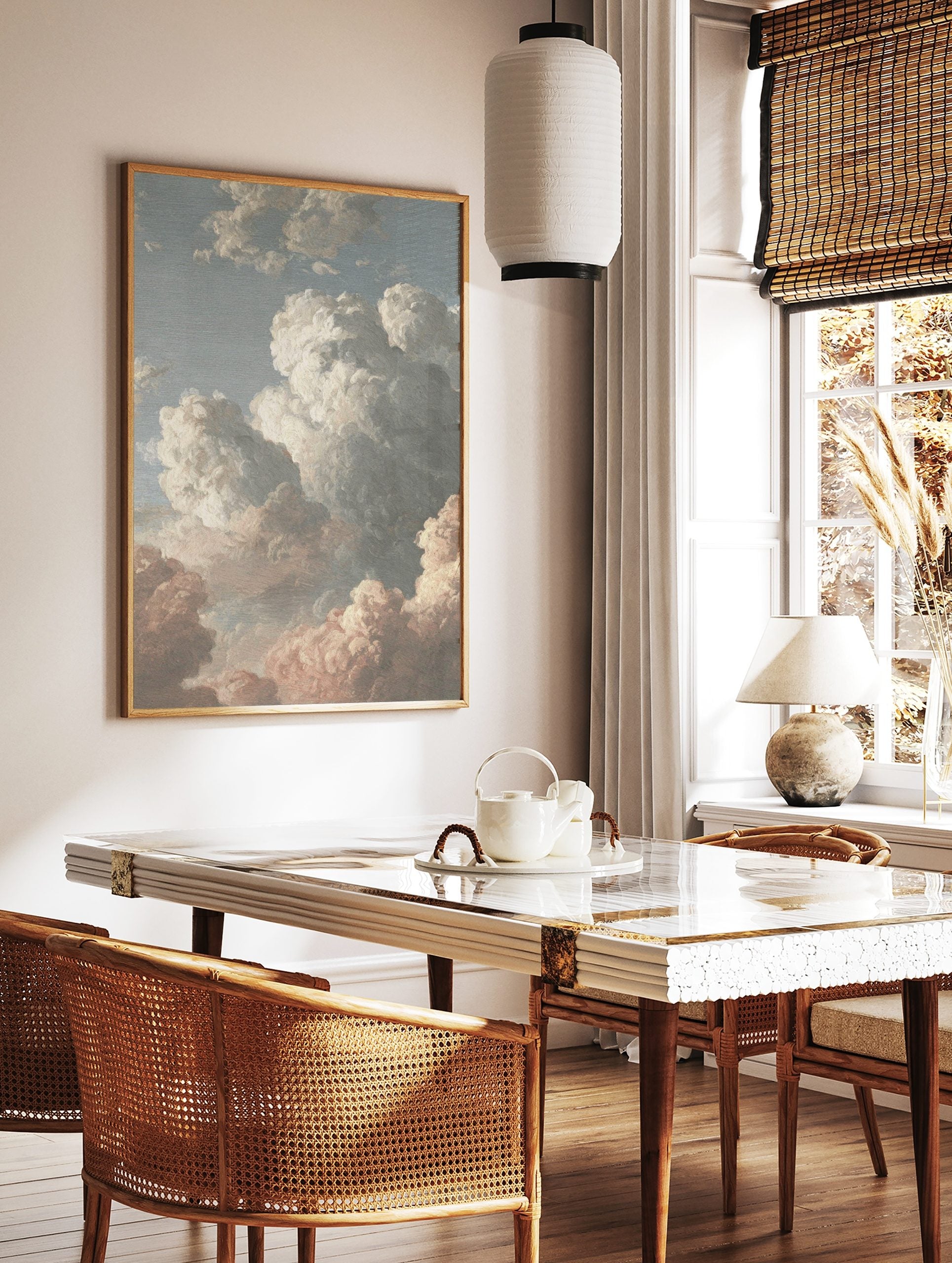 Painterly cloud study art print with white, grey, and pink clouds against a blue sky, in a styled room mockup