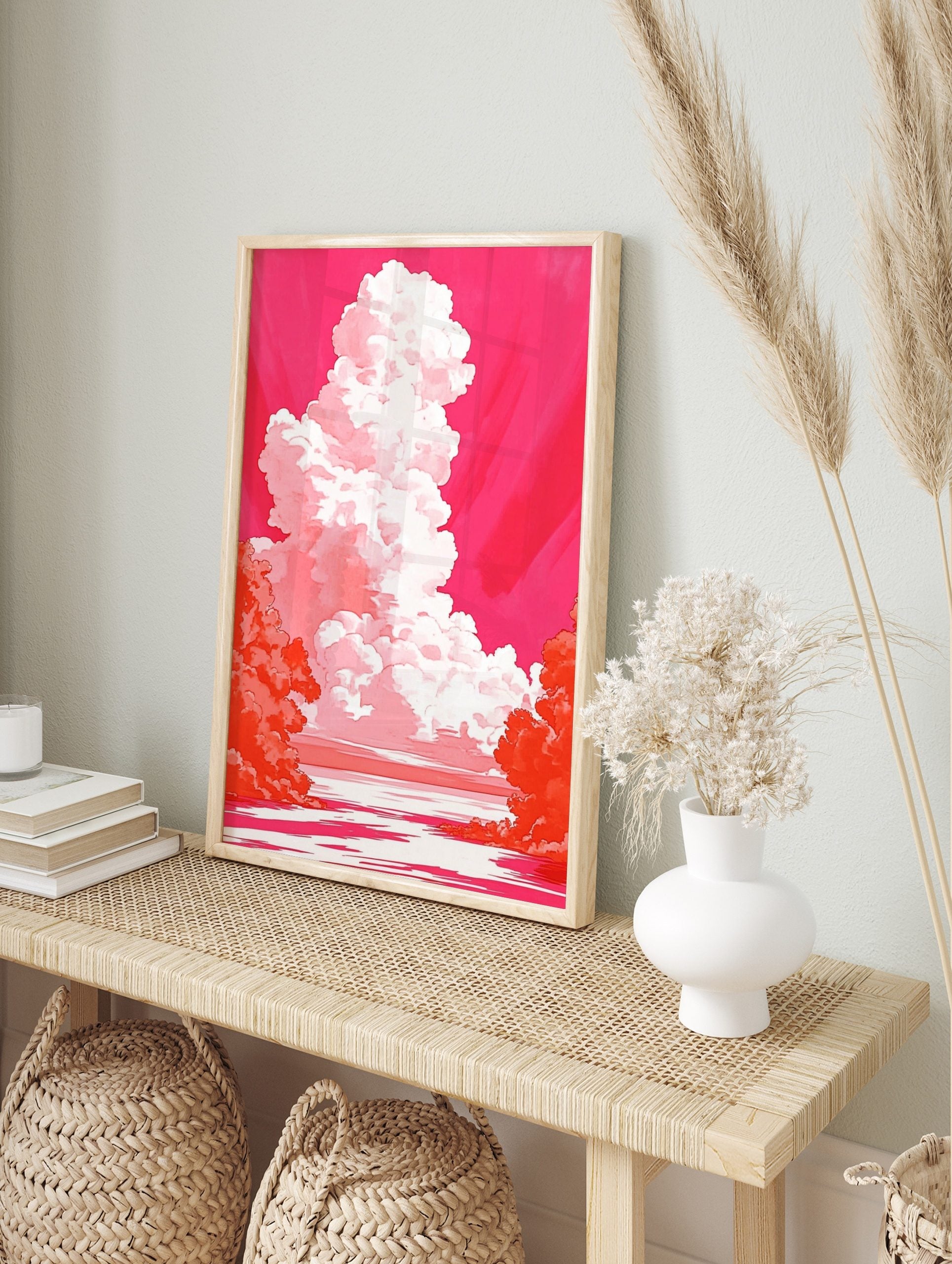 Dramatic towering white and pink cloud against a vibrant magenta sky over water with orange, in an alternate framed mockup