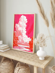 Dramatic towering white and pink cloud against a vibrant magenta sky over water with orange, in an alternate framed mockup