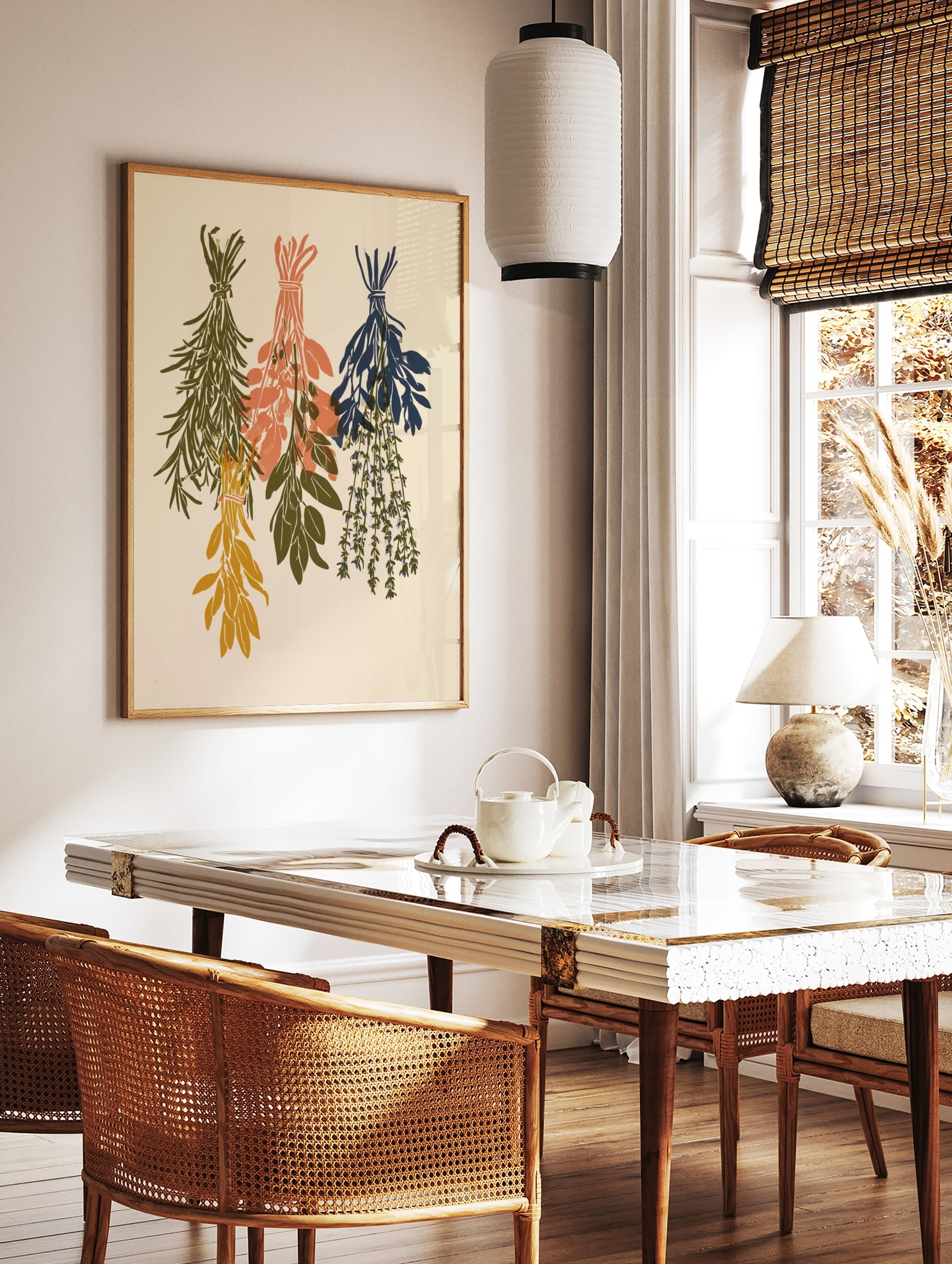 Three bundles of dried herbs in sage green, peach, and navy hanging as a botanical illustration on, in a styled room mockup