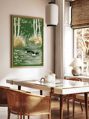 Illustrative print of two ducks swimming in a green pond framed by white birch trees and reeds, in a styled room mockup