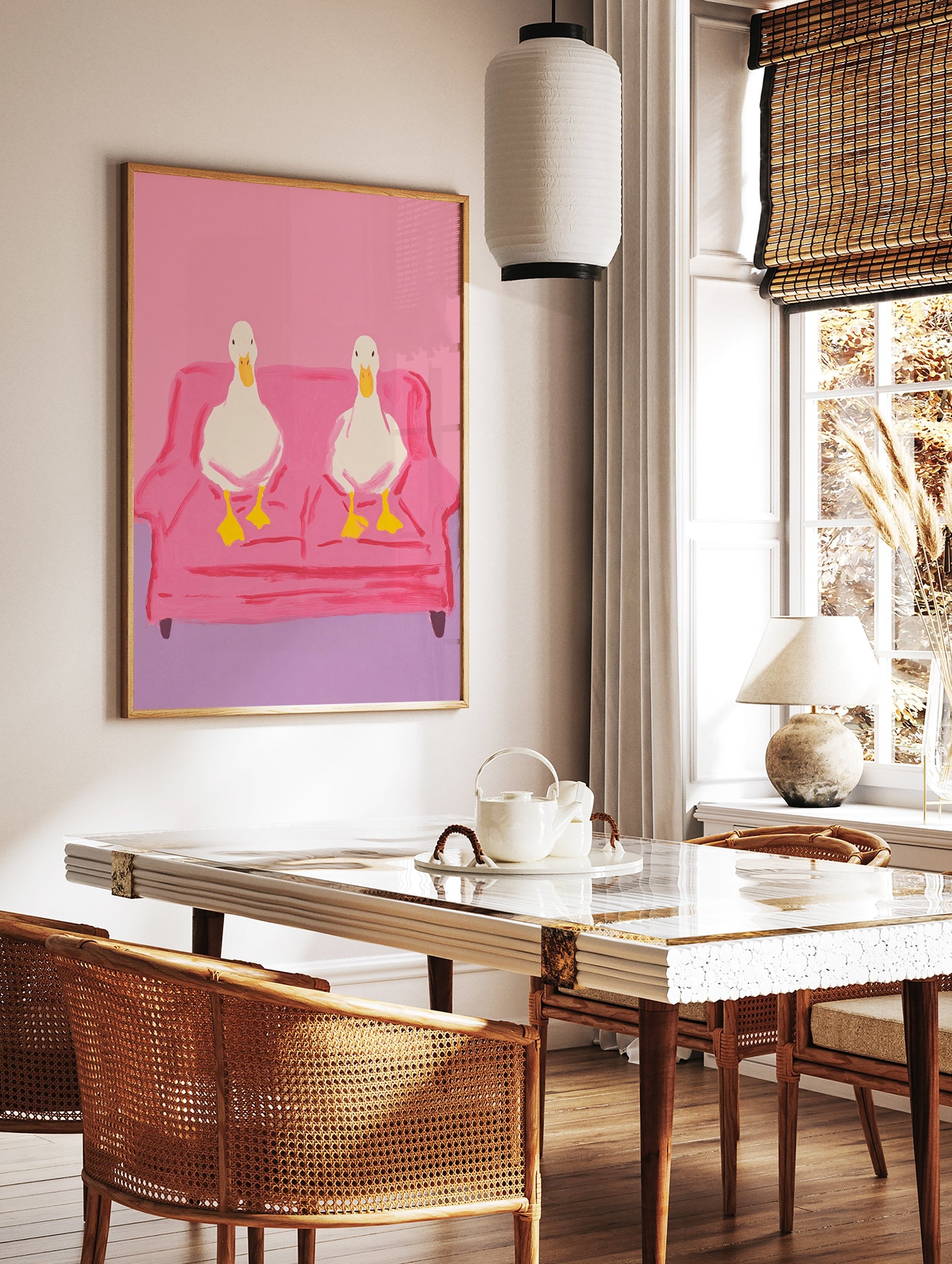 Two white ducks with yellow beaks and feet sitting on a pink couch, illustrated wall art print against a pink background. - Image 2