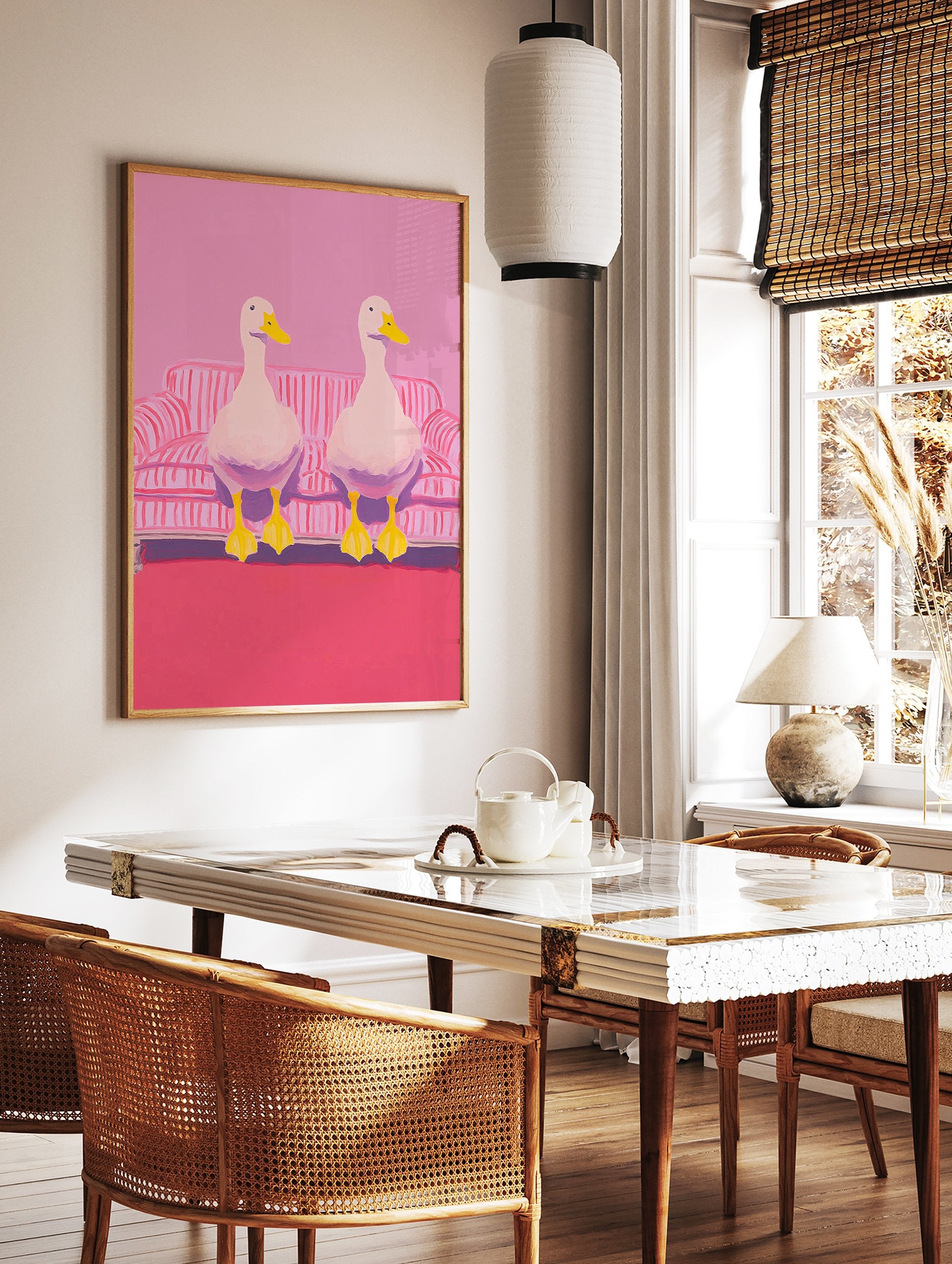Two white ducks with yellow beaks and feet sitting on a pink and white striped couch in pink room. Duck wall art. - Image 2