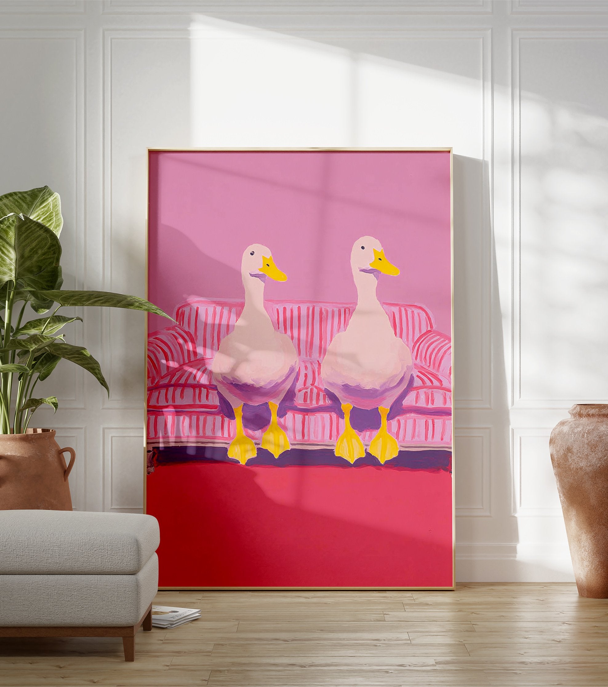 Two white ducks with yellow beaks and feet sitting on a pink and white striped couch in pink room. Duck wall art. - Image 3