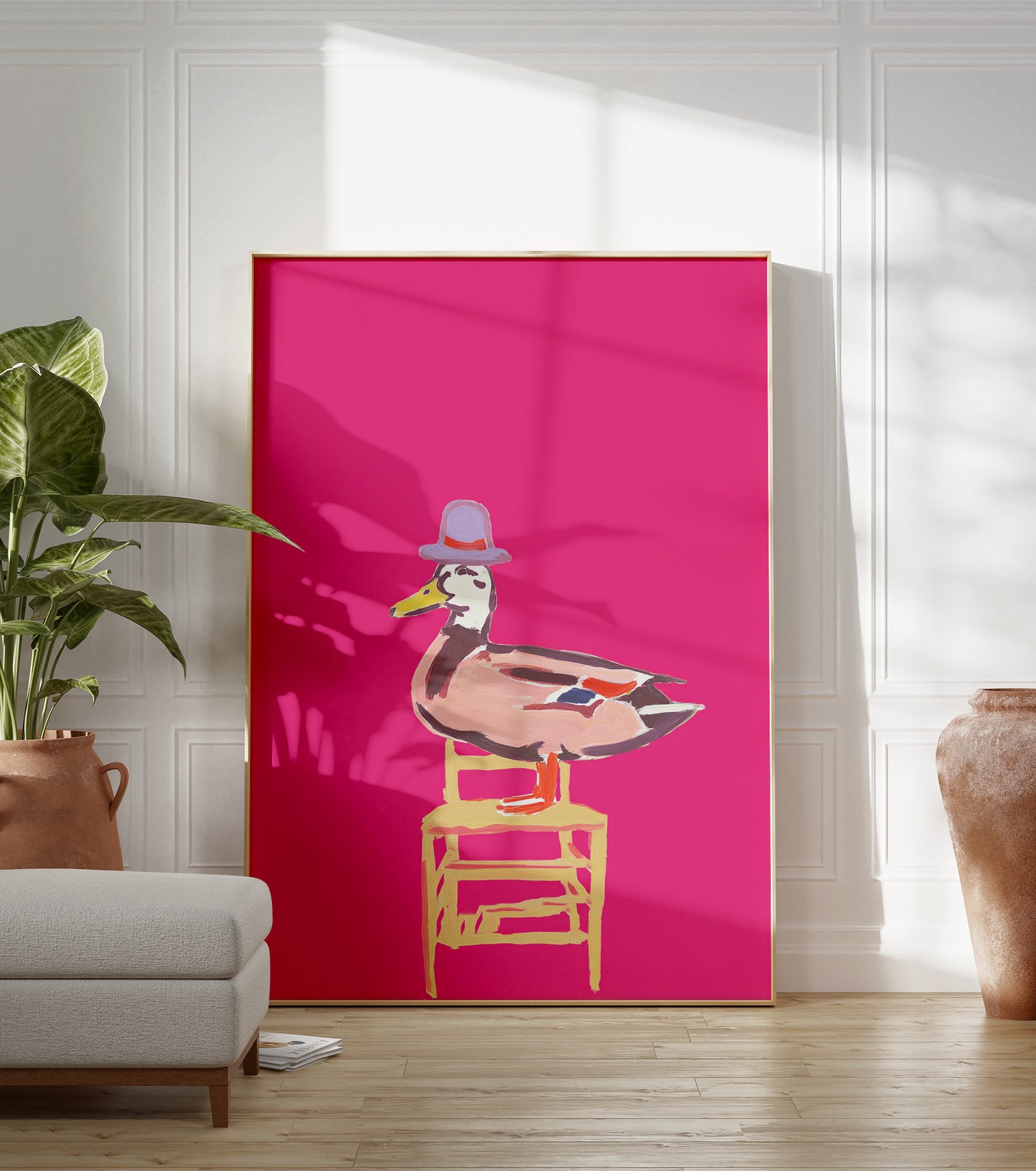 Whimsical duck wall art illustration wearing a purple hat and sitting on a yellow chair against a bright pink background. - Image 3