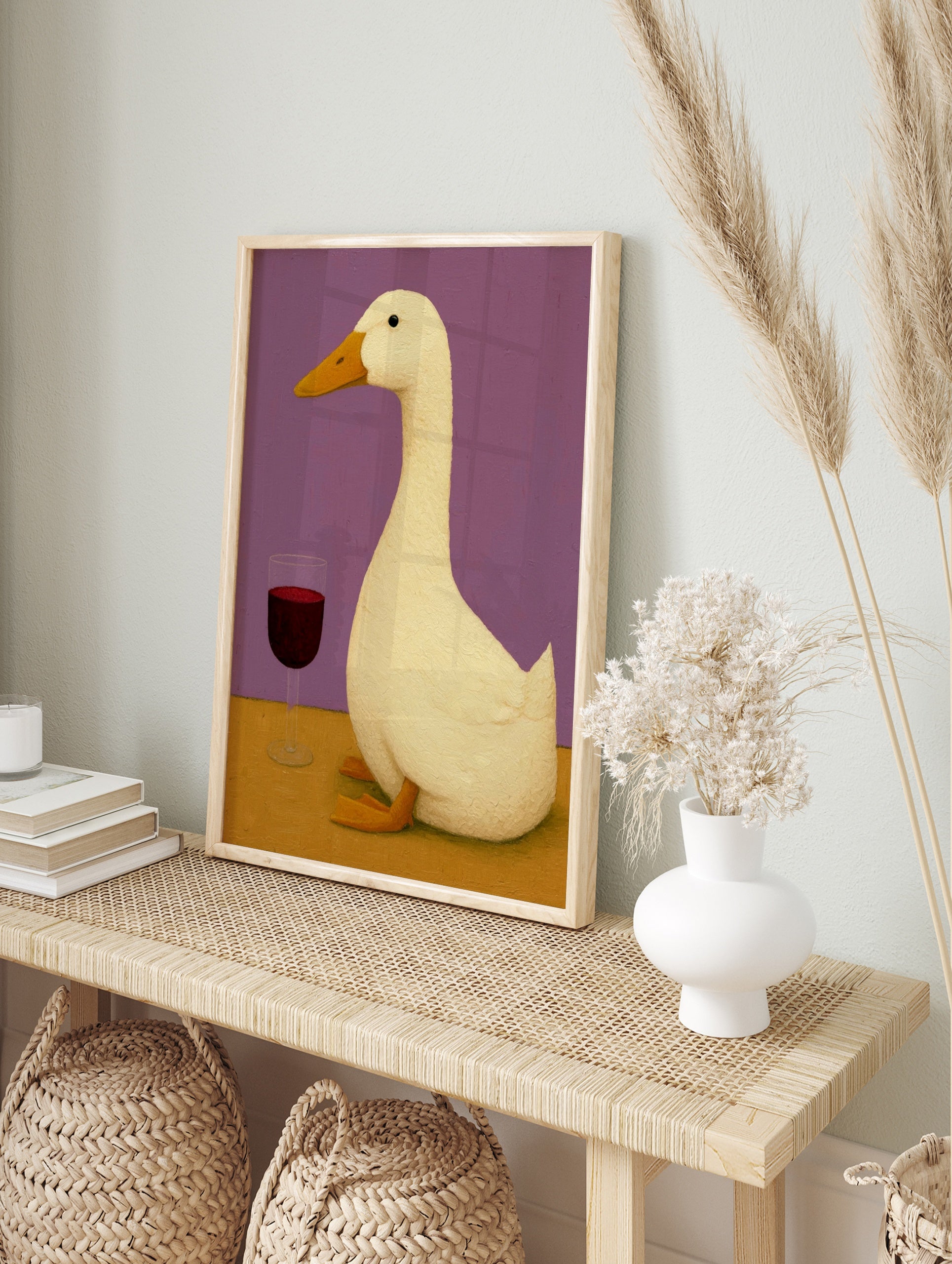 Illustrative art print of a white duck standing next to a glass of red wine against a solid, in an alternate framed mockup