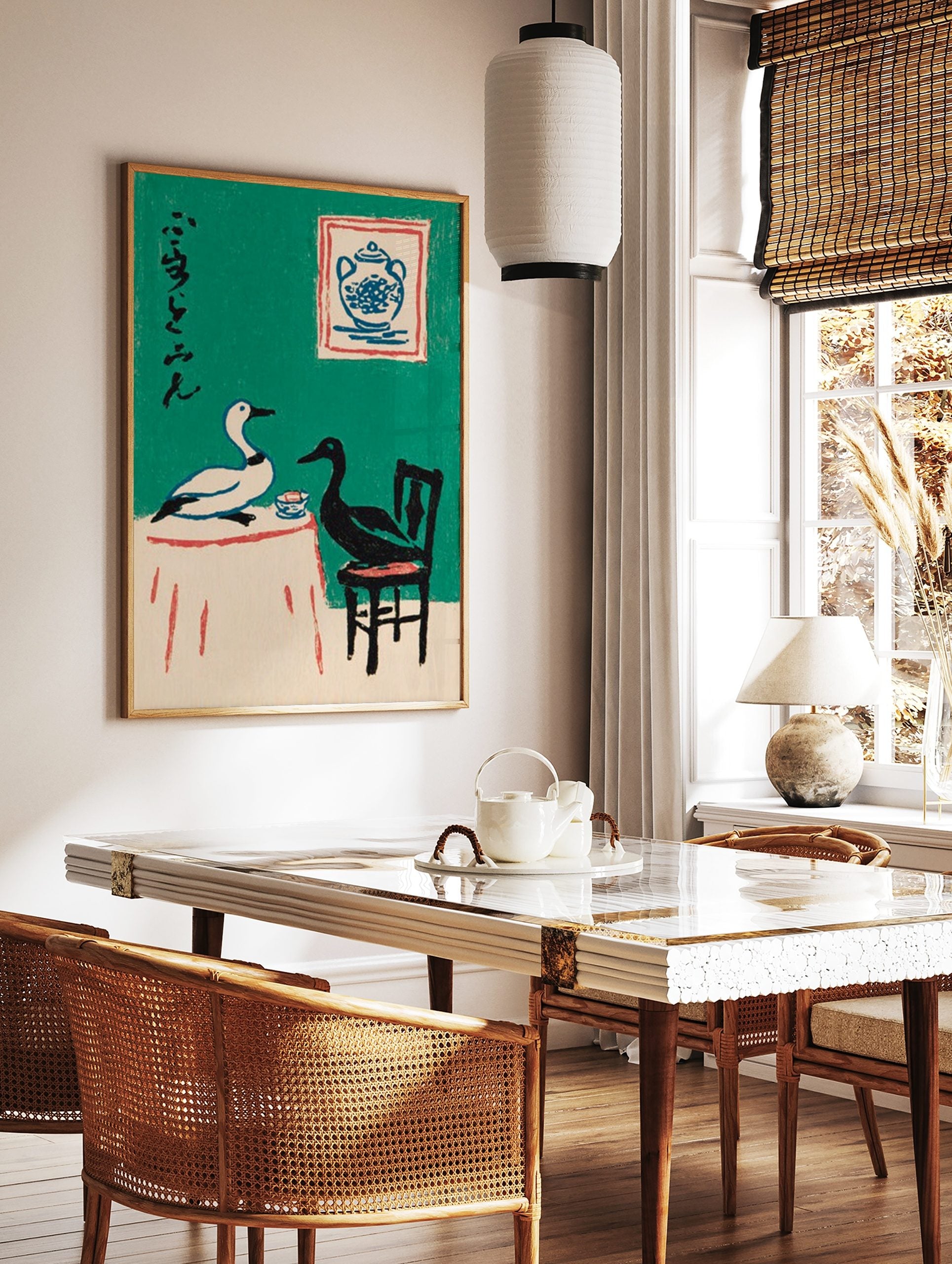 Illustrative art print of a white and black duck at a table with Japanese calligraphy on a green, in a styled room mockup