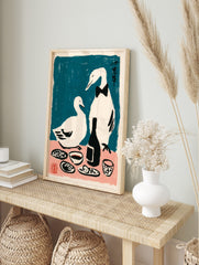 Illustrative print of two white ducks, one in a bow tie, at a dinner table with a bottle, in an alternate framed mockup