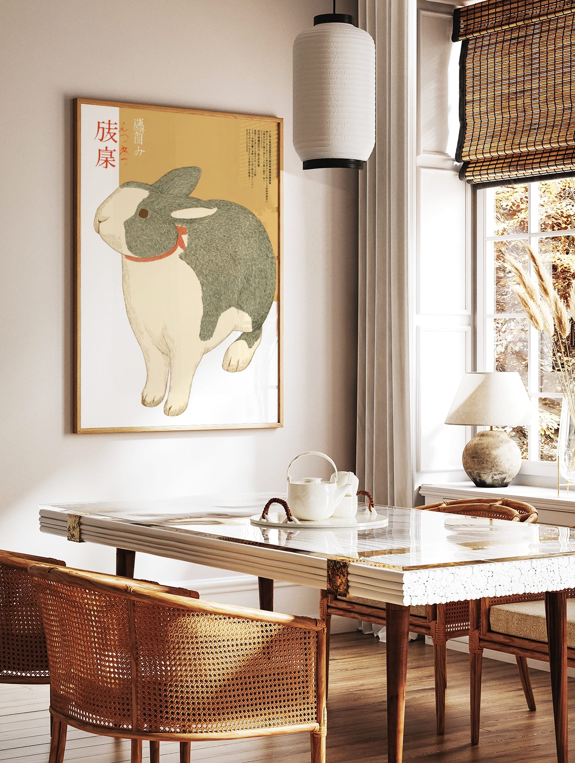 Illustrative print of a grey and white Dutch rabbit with a red ribbon and Japanese text on a beige, in a styled room mockup