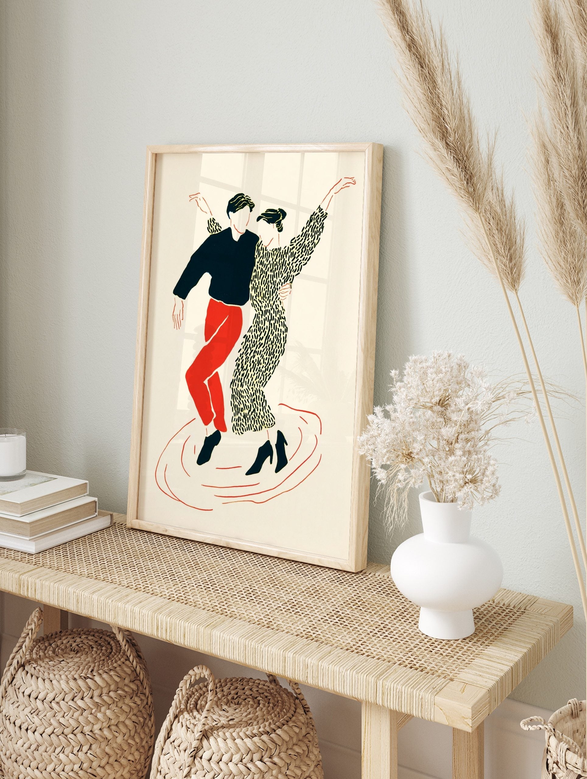 Illustrative print of two dancers in black, red, and cream, in dynamic poses on a plain, in an alternate framed mockup