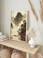 East Asian landscape art print with misty mountains, lake, person in boat, pine trees, and, in an alternate framed mockup
