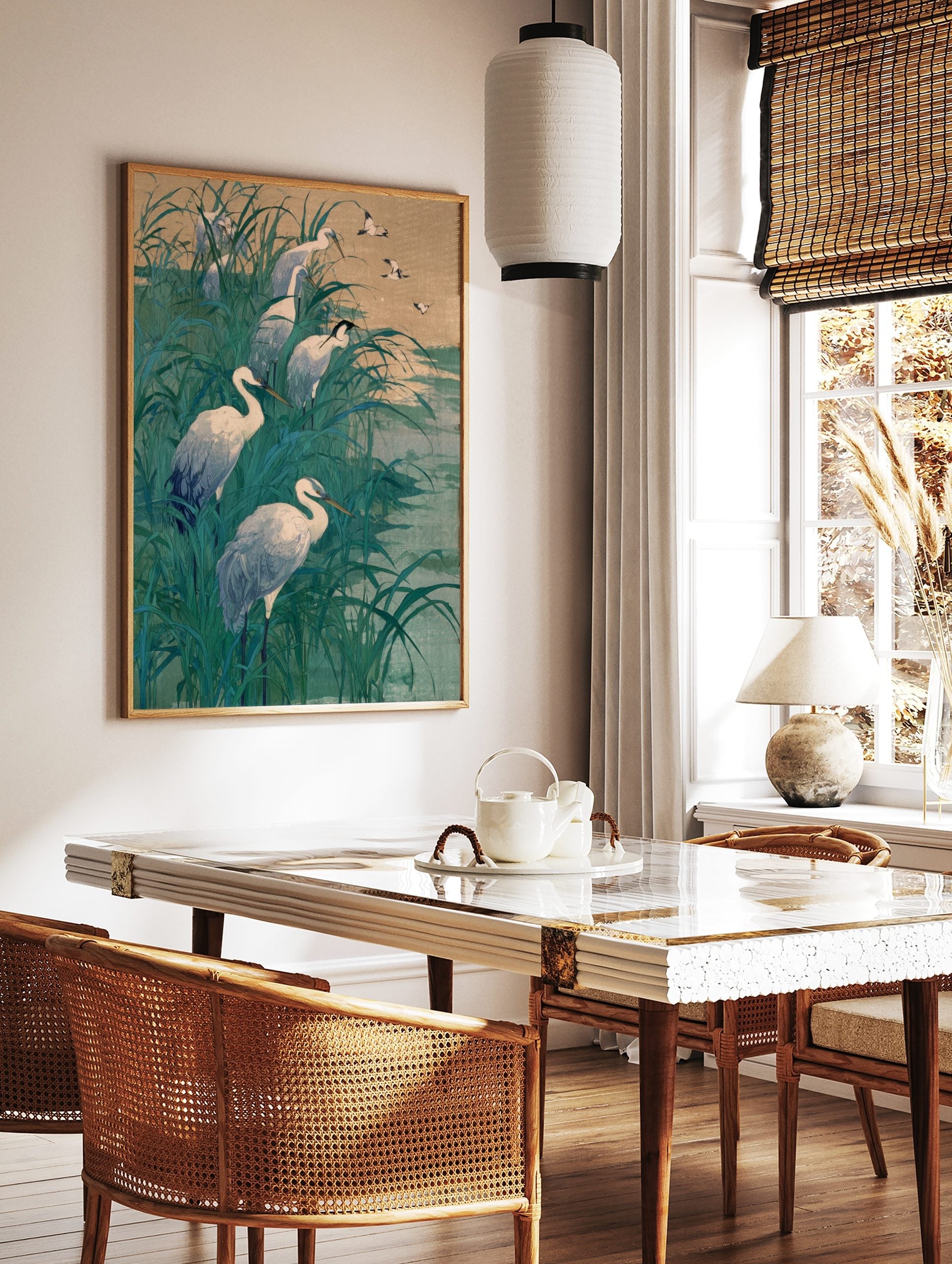 White egrets wading and flying in tall teal marsh grass with a muted sky and water background, in a styled room mockup