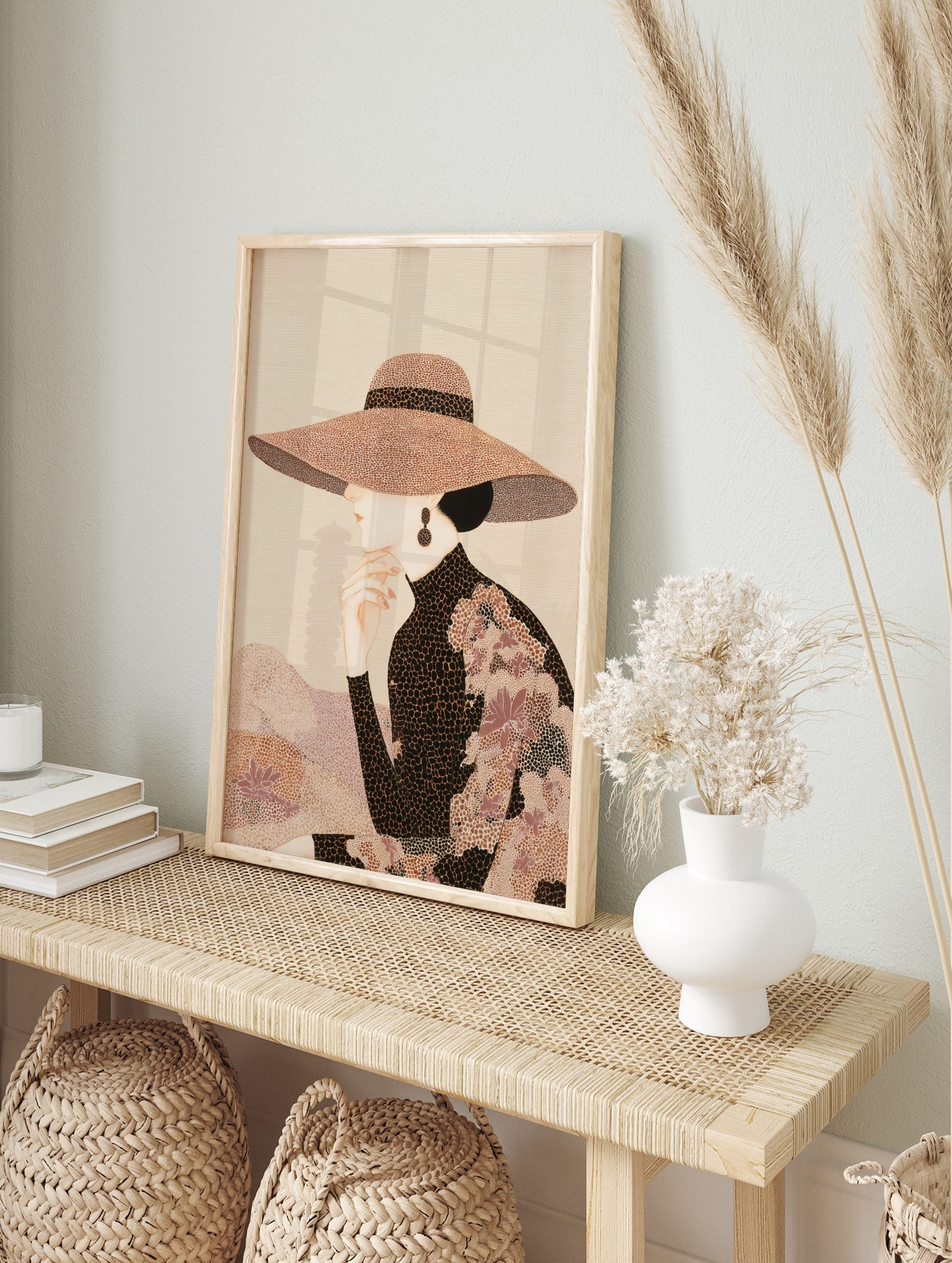 Elegant woman in profile wearing a wide-brimmed patterned hat and high-necked top, hand to, in an alternate framed mockup