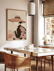 Elegant woman in profile wearing a wide-brimmed patterned hat and high-necked top, hand to chin, in a styled room mockup