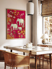 Illustrative elephant family (two adults, one calf) amidst pink and gold flowers on a magenta, in a styled room mockup