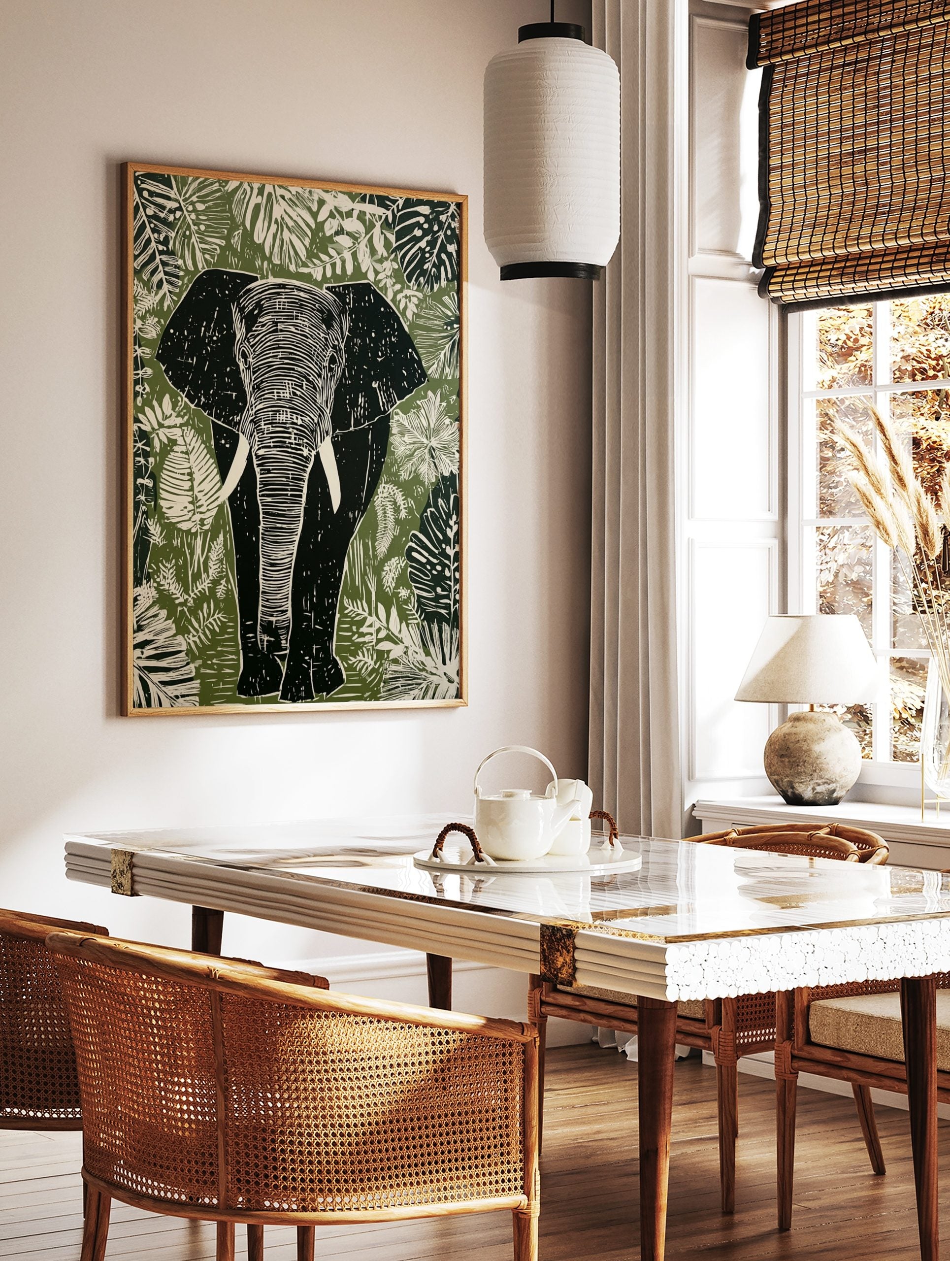 Linocut style elephant wall art print with tropical leaves in green, white, and black tones, in a styled room mockup