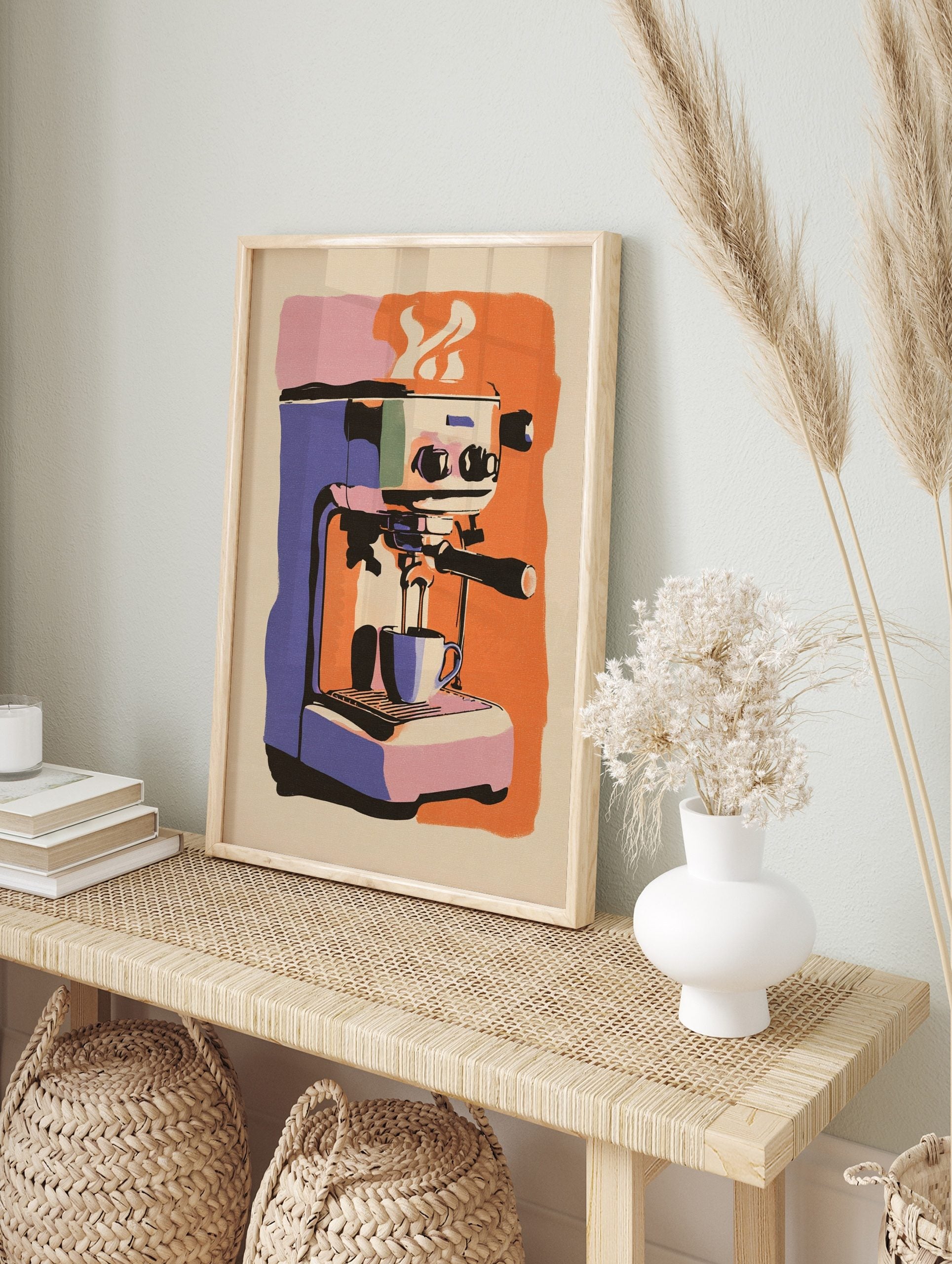 Illustrative print of a purple and orange espresso machine pouring coffee into a cup, with, in an alternate framed mockup