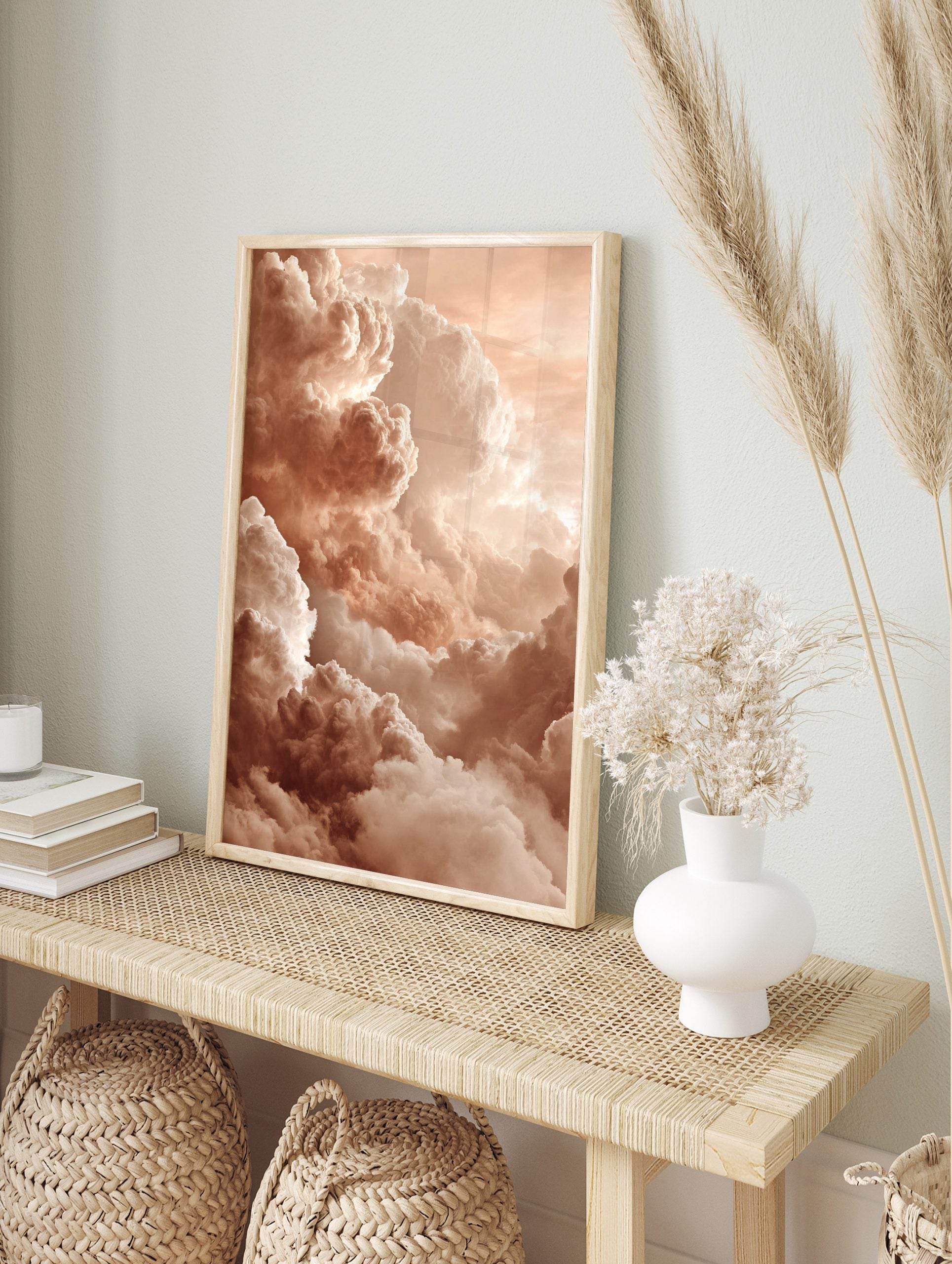 Close-up of voluminous, textured clouds in warm peach and cream tones filling the sky, in an alternate framed mockup