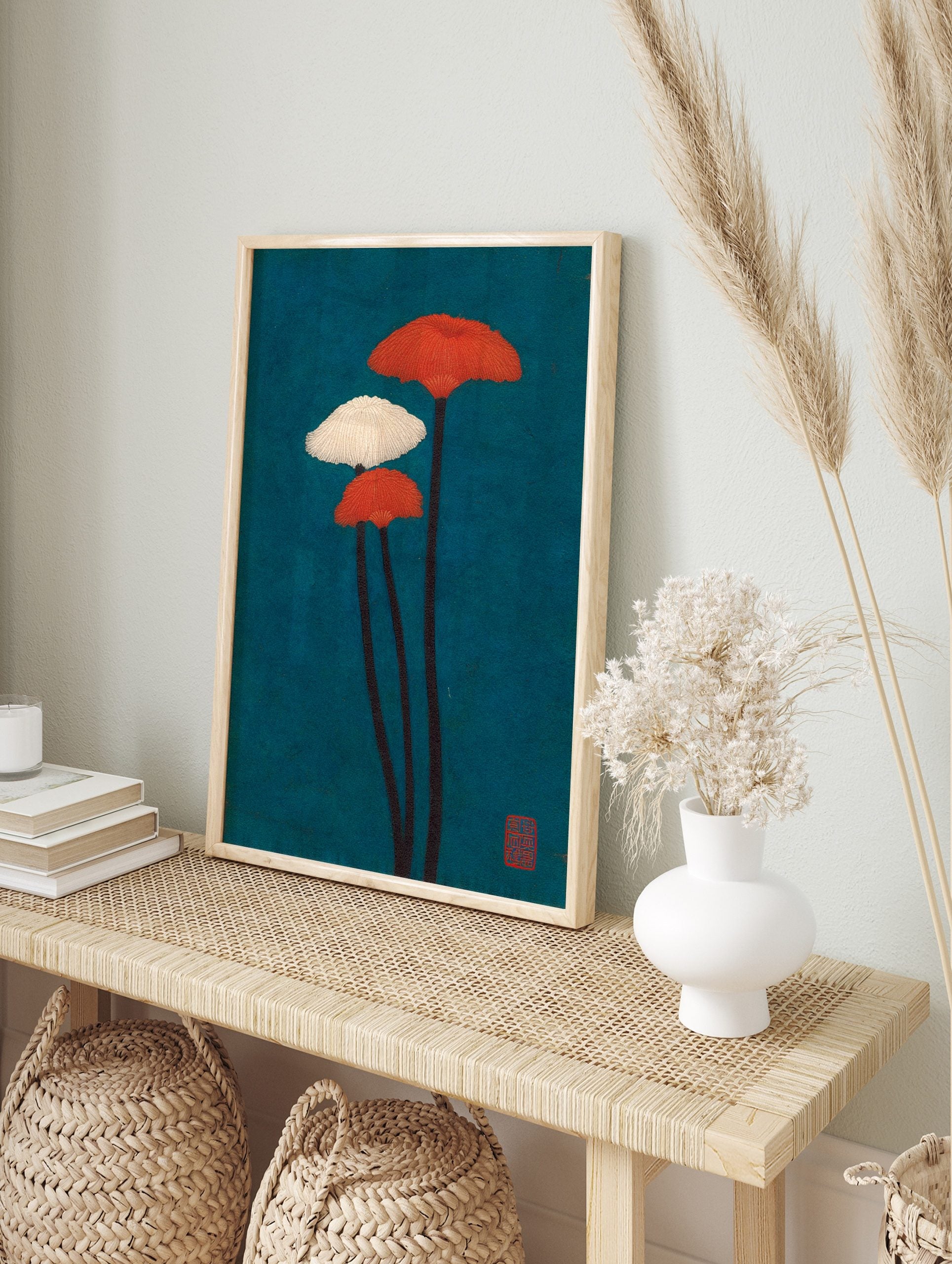 Illustrative wall art of three fanned mushroom plants with orange and white caps against a, in an alternate framed mockup