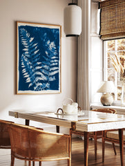 Detailed fern fronds in a blue and white cyanotype style botanical wall art print, in a styled room mockup