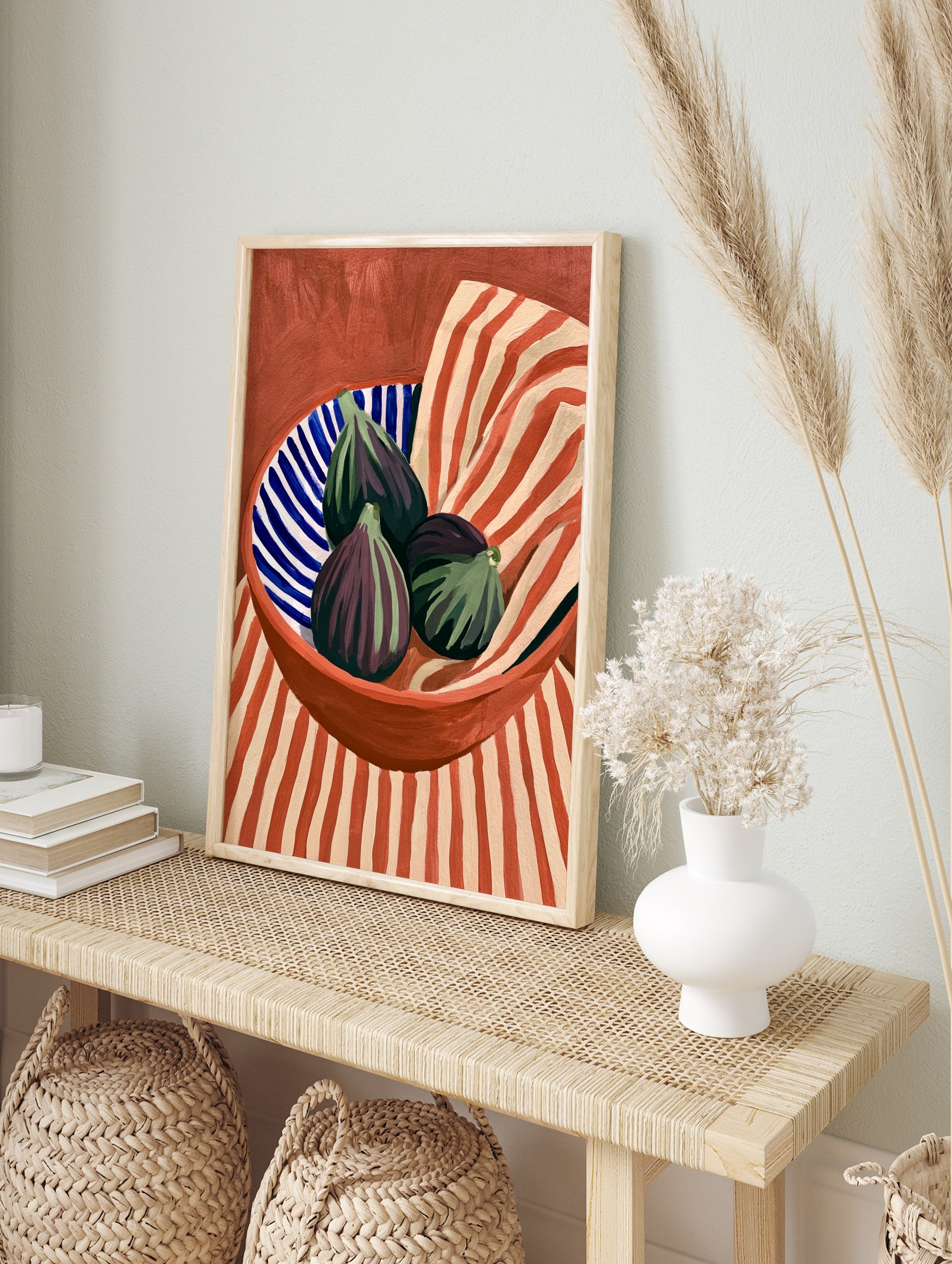 Still life art print of three purple figs in a blue and white striped bowl against a red and, in an alternate framed mockup