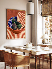 Still life art print of three purple figs in a blue and white striped bowl against a red and beige, in a styled room mockup