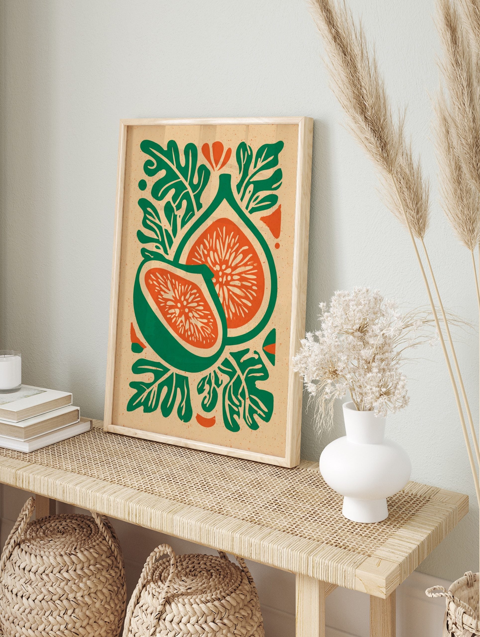 Botanical illustration of two fig fruit halves with green skin, orange flesh, and stylised, in an alternate framed mockup