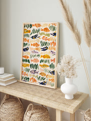 Abstract fish and seaweed illustration with orange, green, and blue brushstrokes on a cream, in an alternate framed mockup