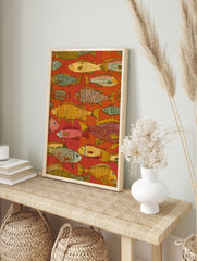 Folk art style fish wall art print with intricate patterns in red, orange, yellow, and green on a warm red background. - Image 3