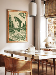 Woodcut style illustration of a jumping trout fish in a lake with pine trees and mountains, framed by an orange border. - Image 3