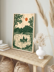 Vintage illustrative art print of a fisherman and dog in a boat on a lake with green trees, in an alternate framed mockup