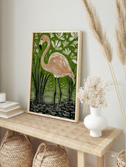 Linocut style art print of a flamingo standing in green water with reeds and white tropical, in an alternate framed mockup